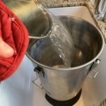 Pouring sugar water solution for hard seltzer into the Ss Brewtech Brew Bucket Mini